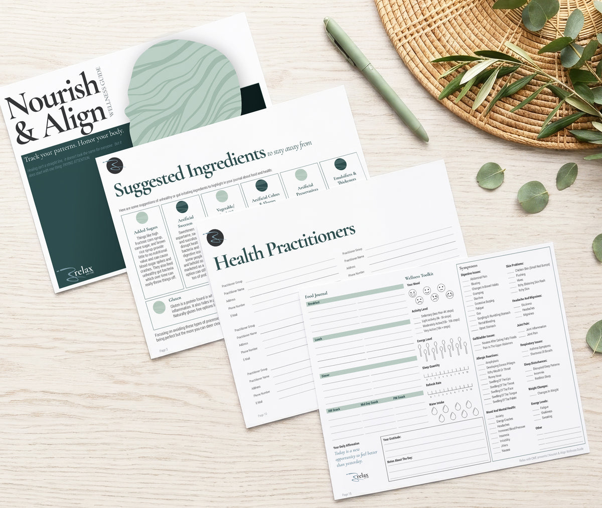 A styled-layout of the interior pages of the Nourish & Align Wellness Guide. Showing the Tracking Pages as well as other pages from the Guide.