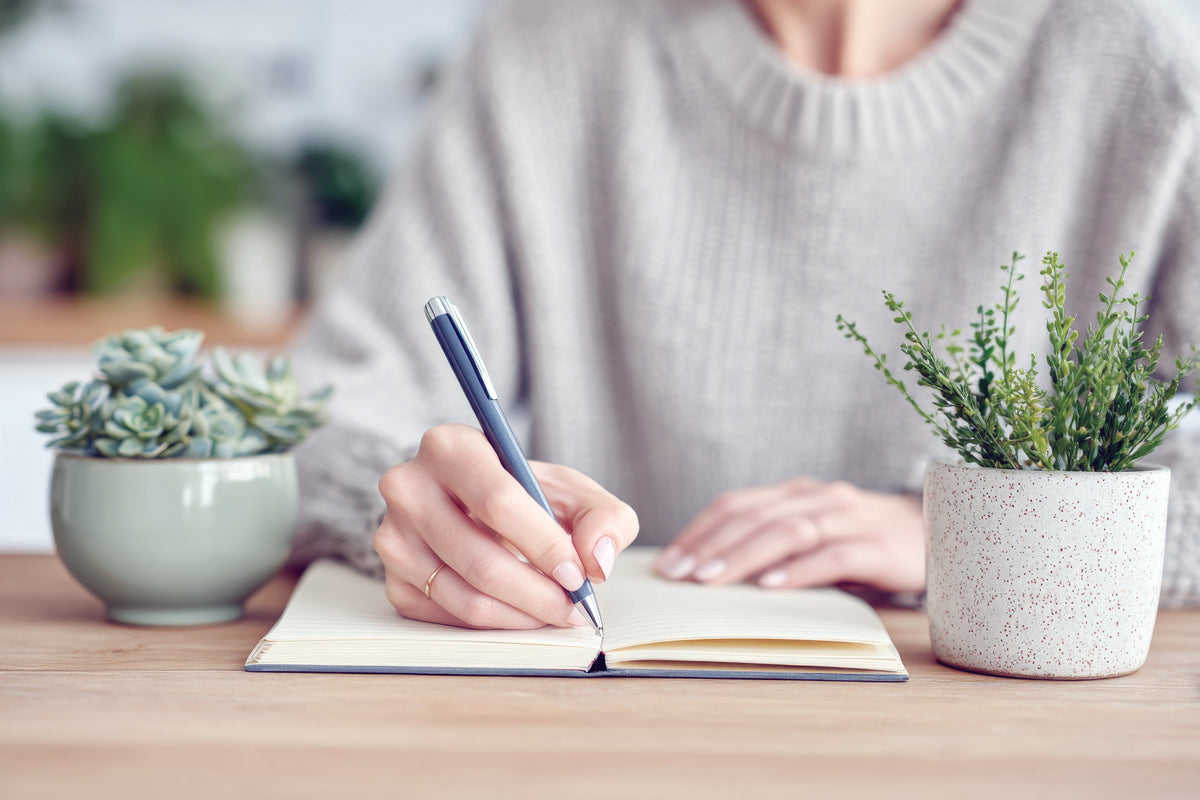 Woman writing in a journal